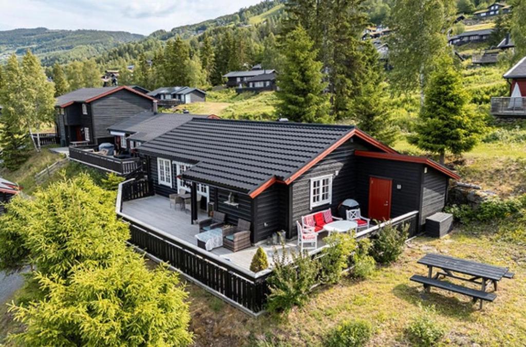 an aerial view of a house with a bench at Sørlia hytte in Hafjell