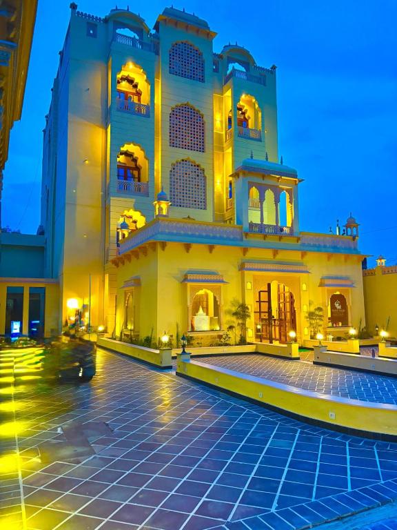 a large building with a courtyard at night at Hotel Anand Bagh -Eraya Hotels in Phulera