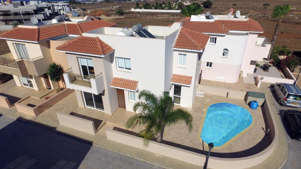 an overhead view of a house with a swimming pool at Chara Cynthiana Villa in Paralimni