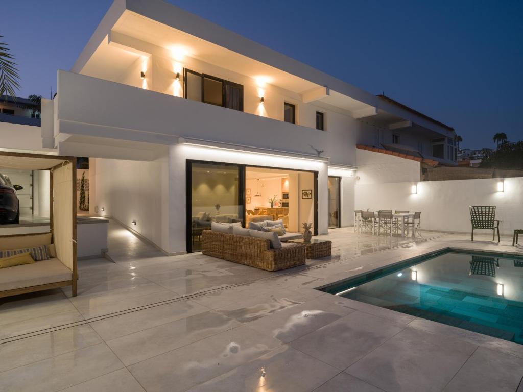 a villa with a swimming pool and a house at Las Burras Ocean Front Views in San Agustin