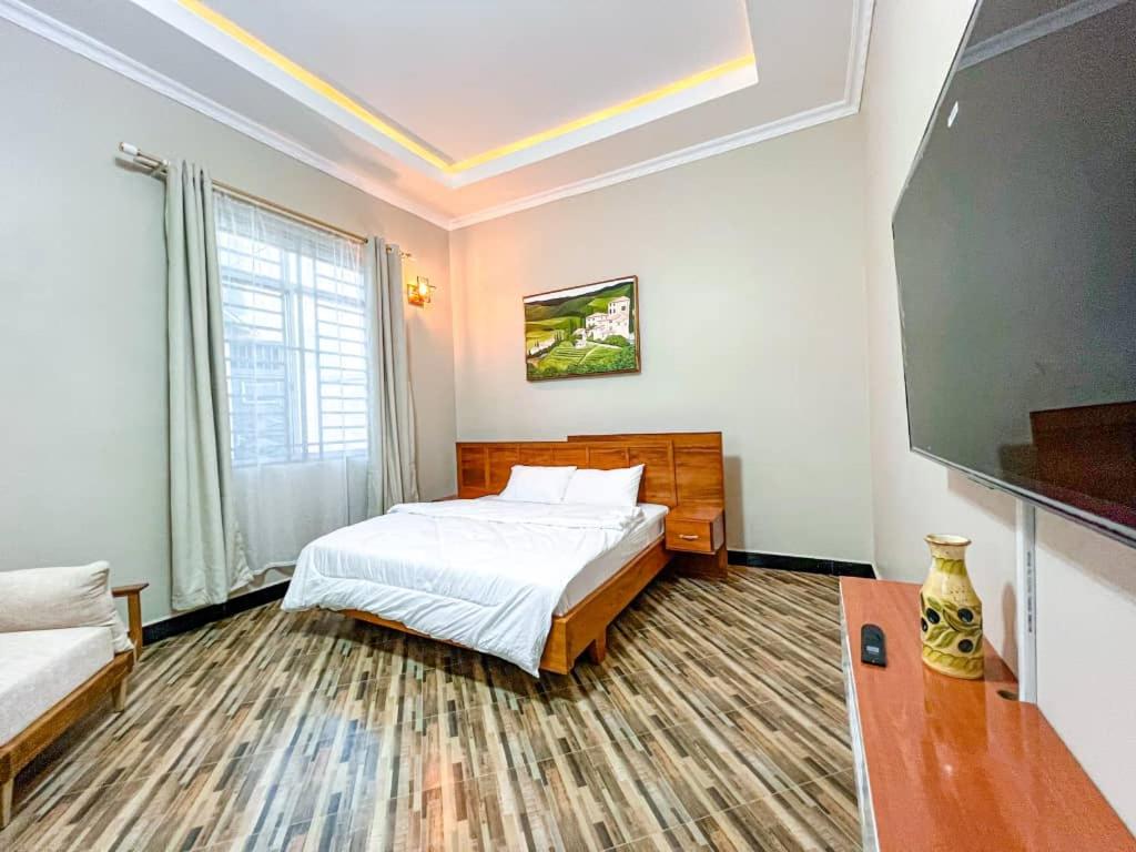 a bedroom with a bed and a tv in it at Golden Homes in Dodoma