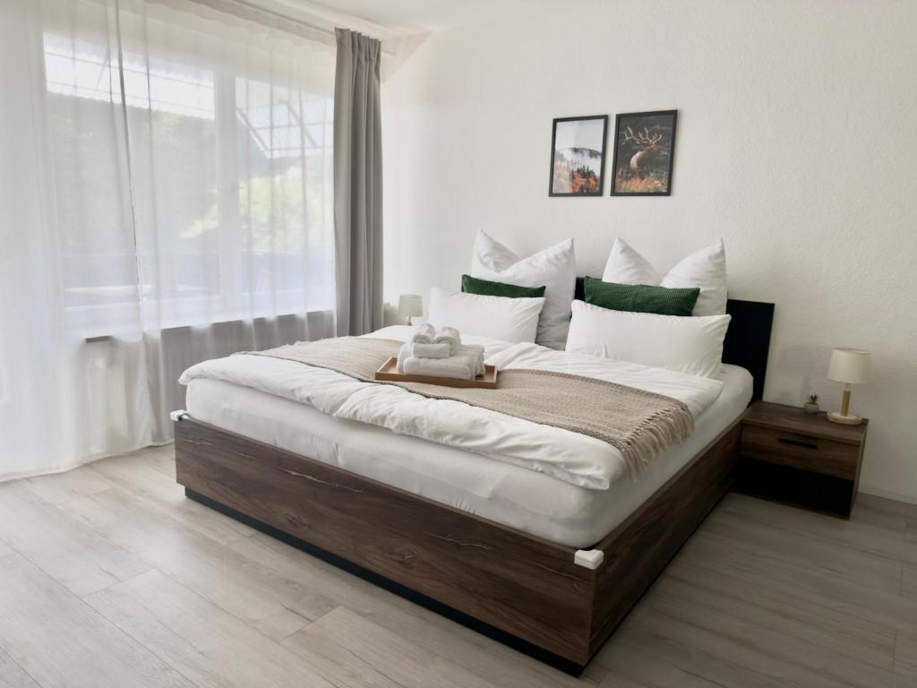 a bedroom with a large bed with a teddy bear on it at 1-Zimmer-Apartment in der Nähe der Therme und Hängebrücke in Bad Wildbad
