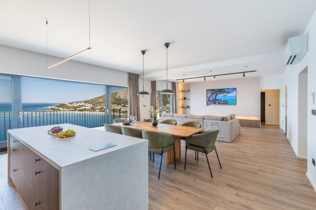 a kitchen and living room with a table and chairs at Penthouse Andro, Omis in Omiš