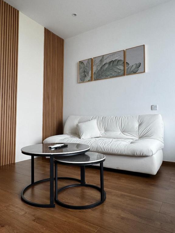 a living room with a white couch and a table at Summermall suits samarahan in Kota Samarahan