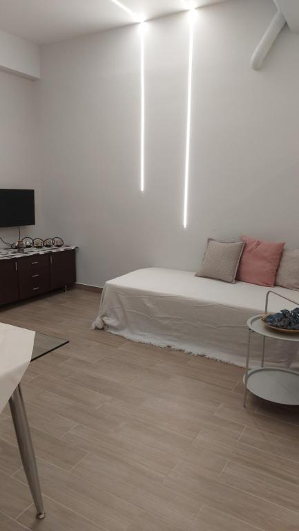 a white room with a bed and a table at Galazio suites 3 in Salamís