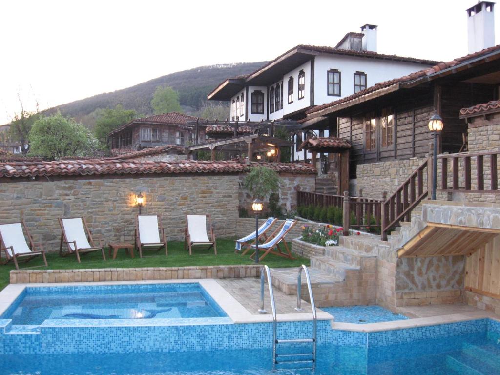 a house with a swimming pool in front of a house at Sava Cupetsa Guest House in Zheravna