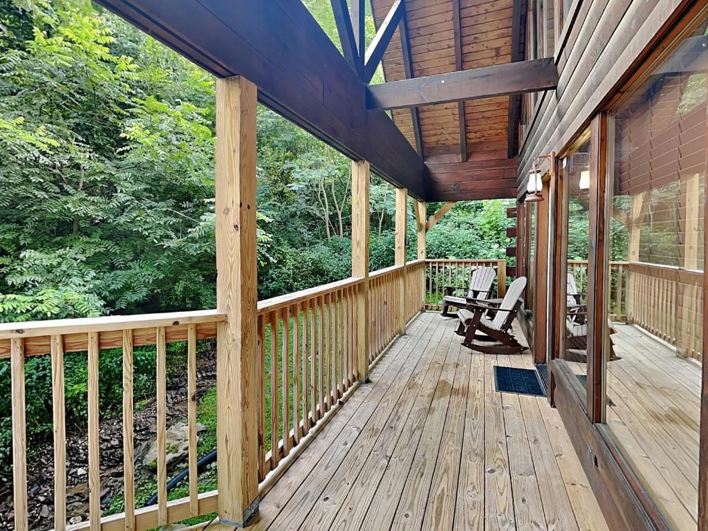 a wooden porch of a house with trees at Simply Unforgettable in Gatlinburg