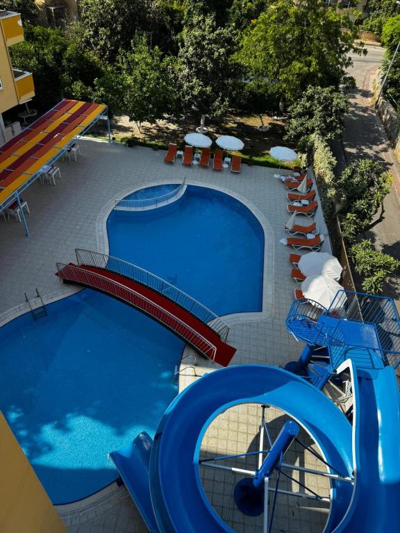 a swimming pool with a water slide in a resort at Rose Garden Apart Hotel in Alanya