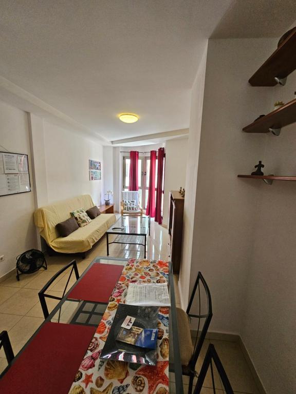 a living room with a table and a couch at Residencial Sol Suite in Telde
