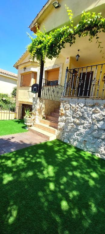 a house with a tree in the front yard at Casa Rural Rincones de Albares in Albares
