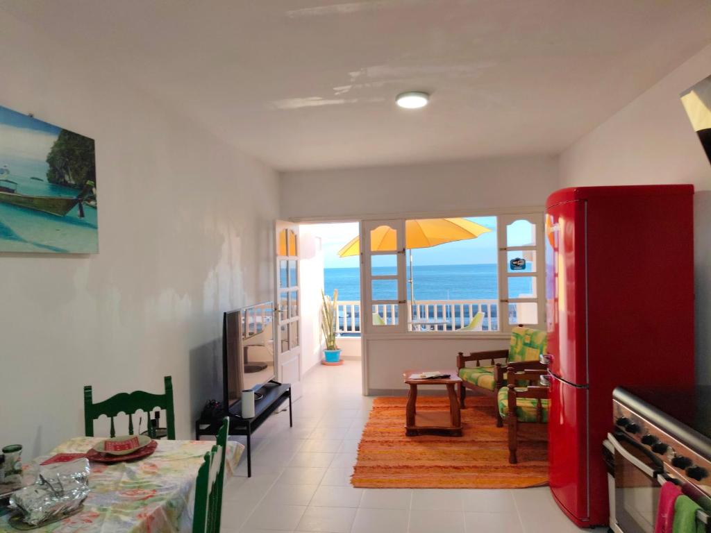 a kitchen with a red refrigerator and a view of the ocean at Vistas al mar 2 in Tías