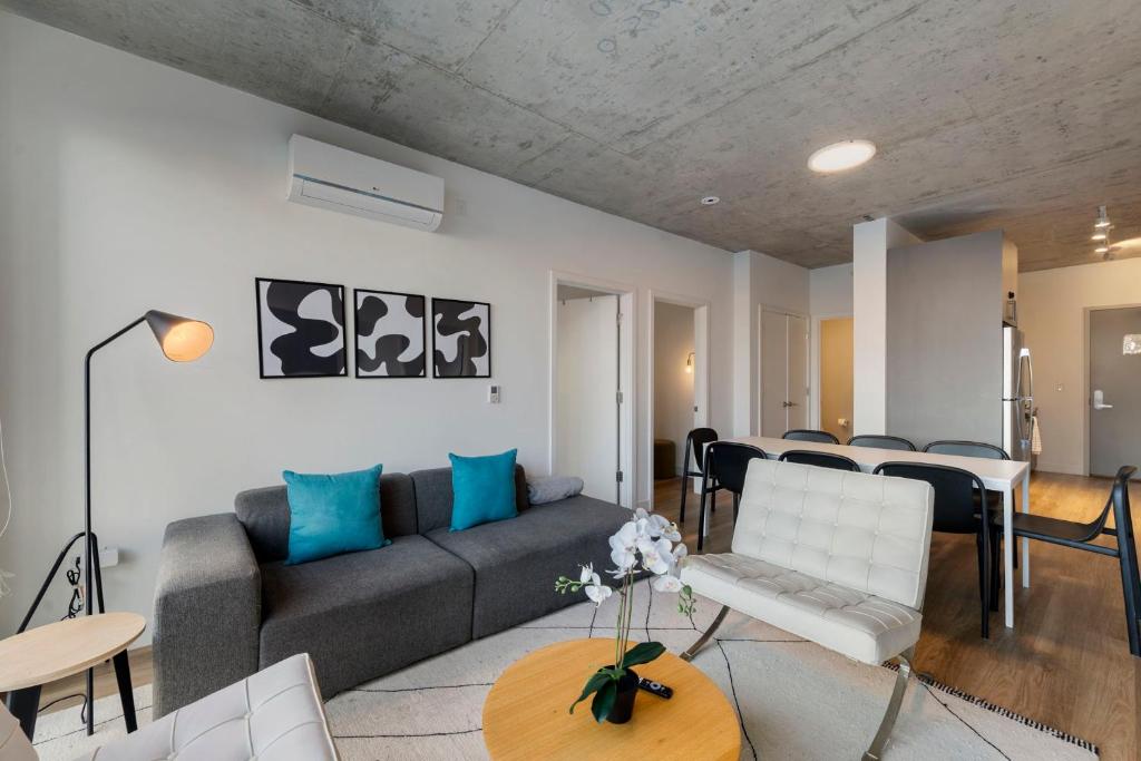 a living room with a couch and a table at Chic 4-Bedroom with Skyline Views & Amenities in Chicago