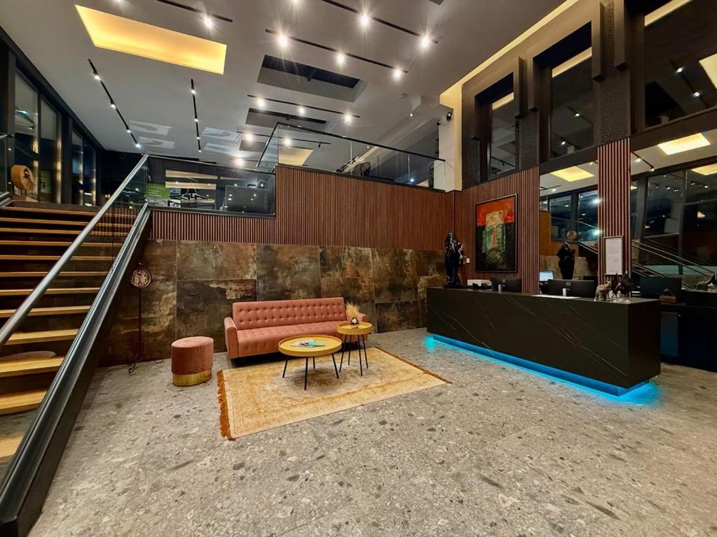 a lobby with a couch and a table and stairs at LAKEVIEW Hotel & Apartments in Mavrovo