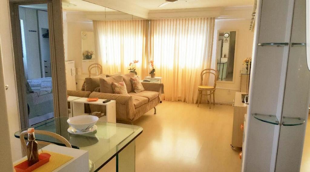 a living room with a couch and a table at Flat em Boa Viagem in Recife