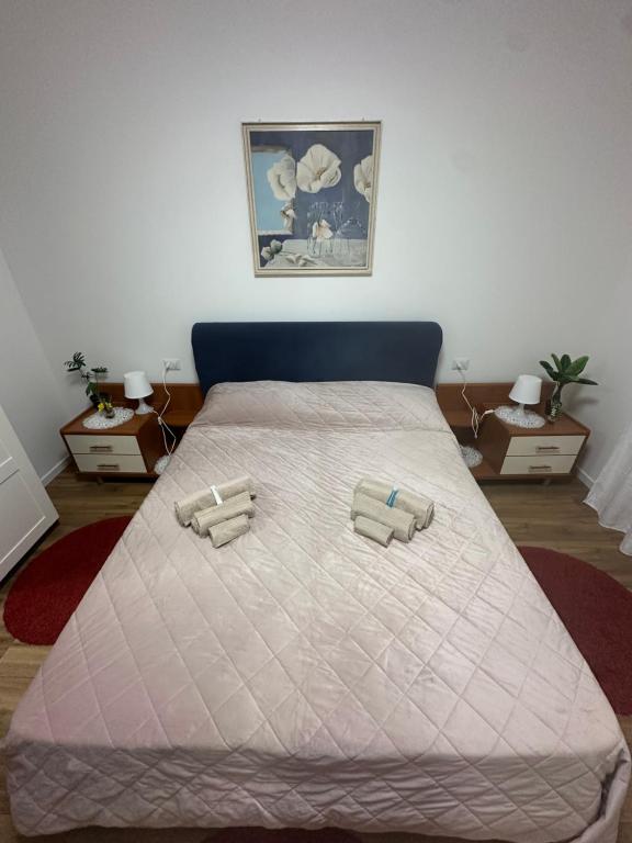 a bedroom with a bed with two pillows on it at F-House in Padova