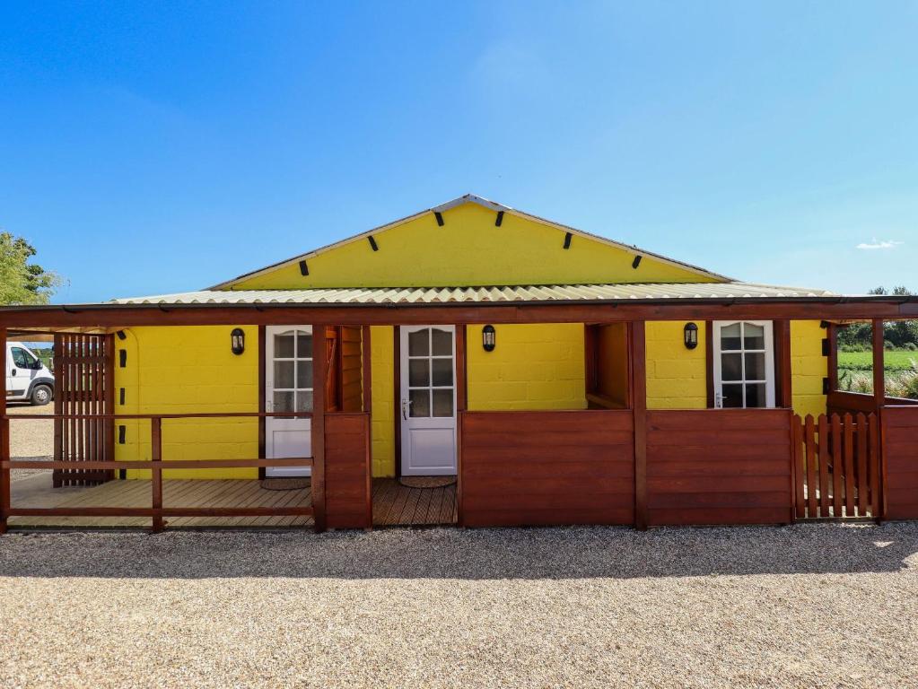 a yellow and orange building with a porch at Lancaster in Lincoln