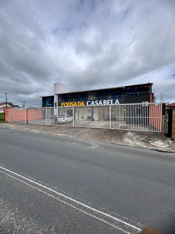 a fence next to a road next to a street at Pousada Casa Bela in Campina Grande