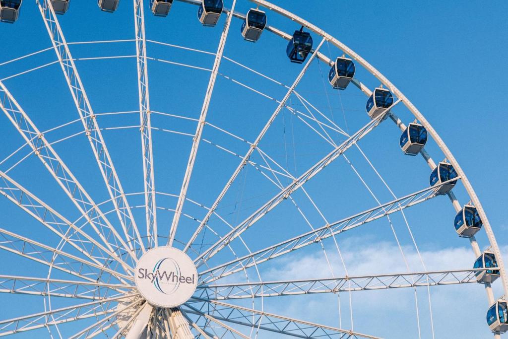 a ferris wheel in front of a blue sky at voco The Shelby - Myrtle Beach by IHG in Myrtle Beach