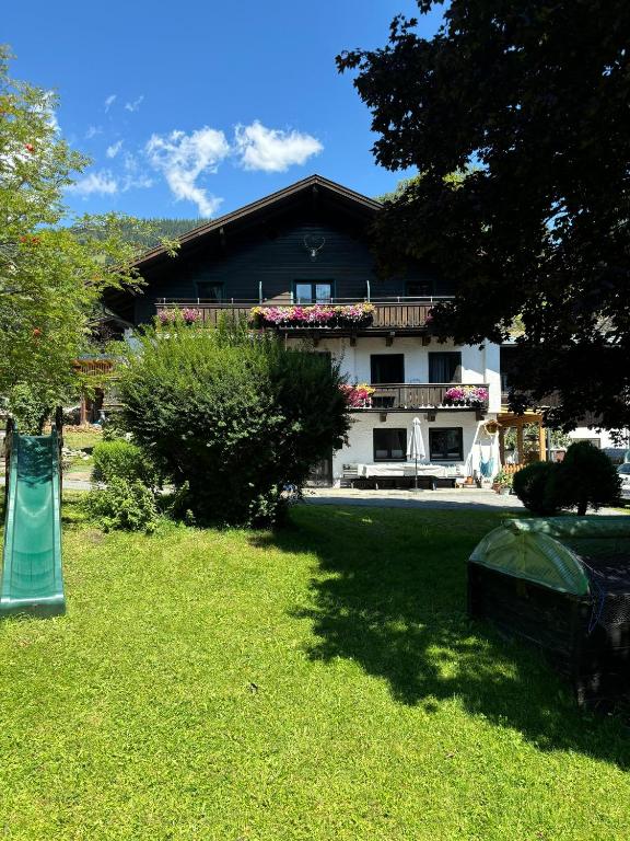 a house with a playground in front of a yard at Appartement Unterstein 1 in Niedernsill