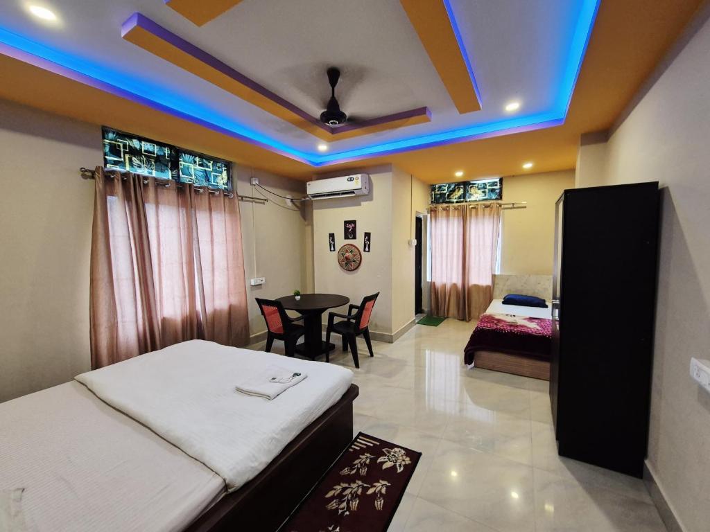 a hotel room with a bed and a table at Serene Dawn Homestay in Guwahati