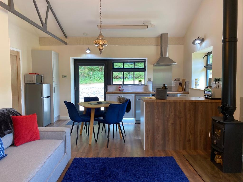 a living room and kitchen with a table and chairs at Sun Valley Retreat in Milton