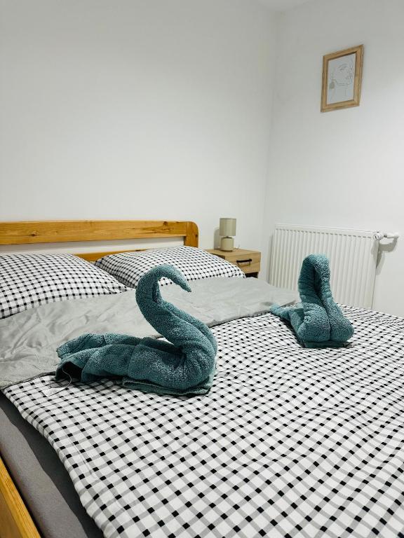 two stuffed snakes sitting on a bed at Górska Ostoja in Jugów