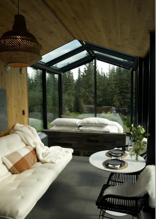 a room with a couch and a bed and a table at Wilding Hotels Fairbanks in Fairbanks