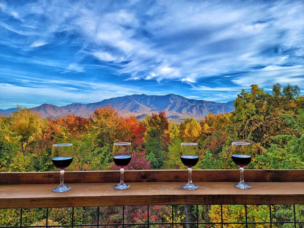 three glasses of wine sitting on a ledge with a view at Glimpse of Bearadise in Gatlinburg