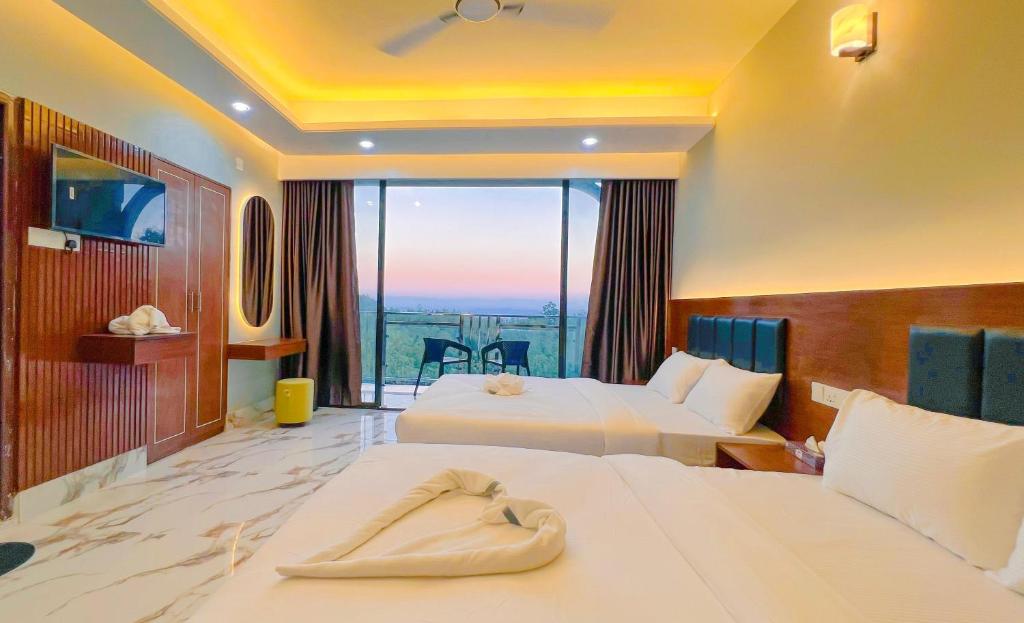 a hotel room with two beds and a balcony at Cloudy Inn Resort in Bāndarban