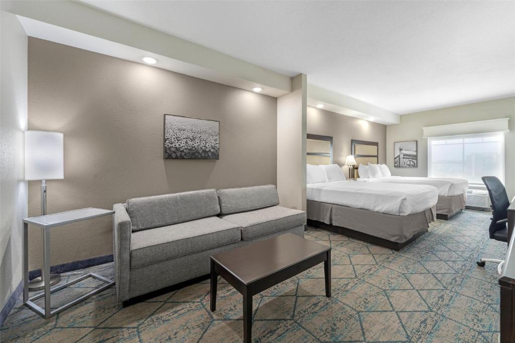 a hotel room with a bed and a couch at Best Western Plus McPherson in McPherson