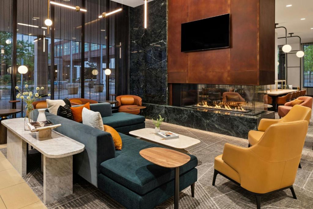 a living room with a couch and a fireplace at Sheraton Minneapolis Downtown Convention Center in Minneapolis