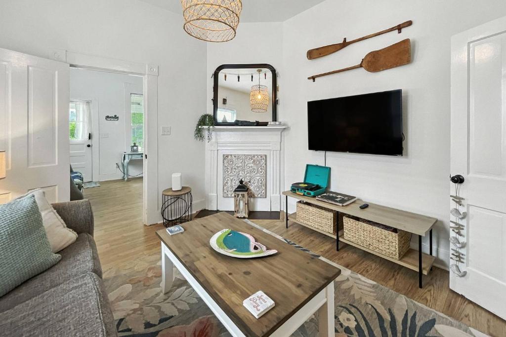 a living room with a couch and a table at Odie's Oasis on Union in Brunswick