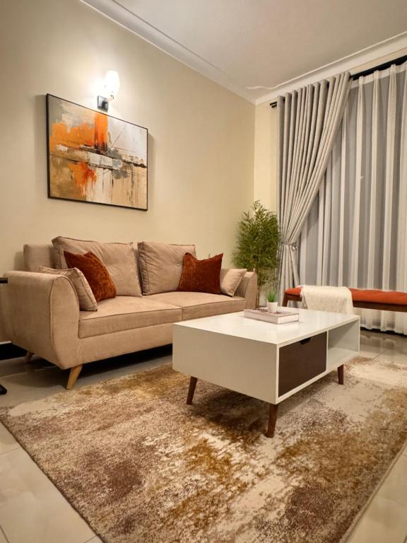 a living room with a couch and a coffee table at Cozy Home in Entebbe in Entebbe