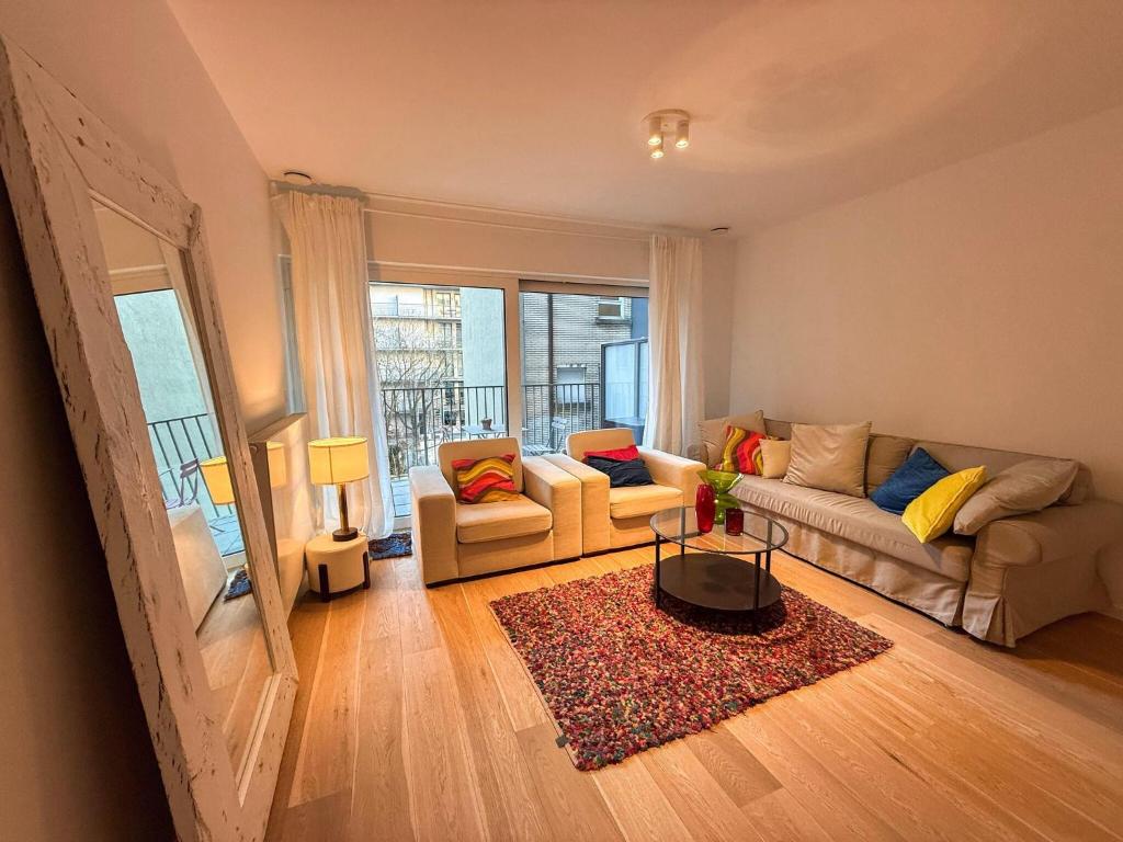 a living room with a couch and a table at Brussels City Apartment in Brussels