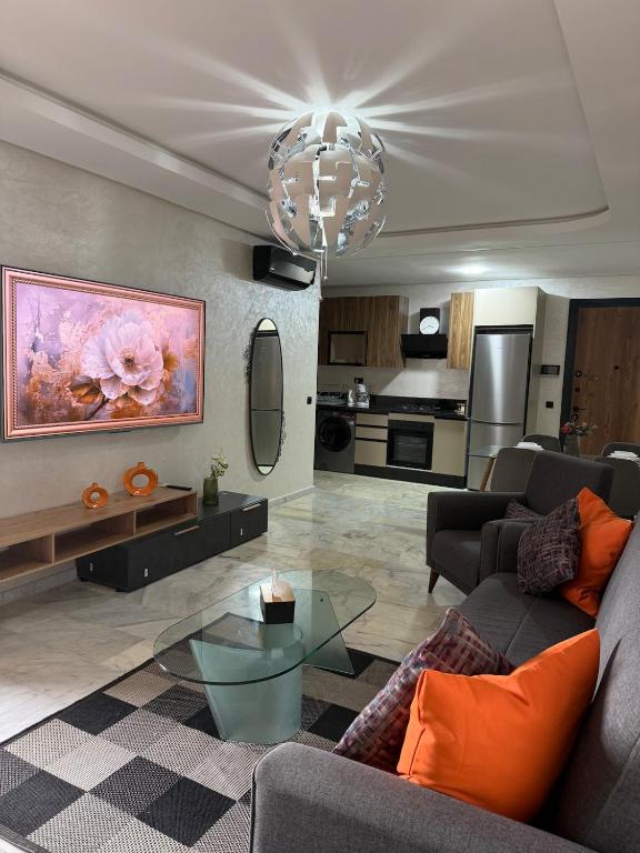 a living room with a couch and a glass table at Studio in M'océan in Mohammedia