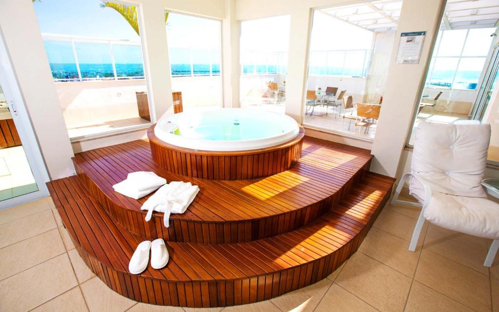 baño grande con bañera de hidromasaje en el centro en Flat Saint Moritz, en Brasilia