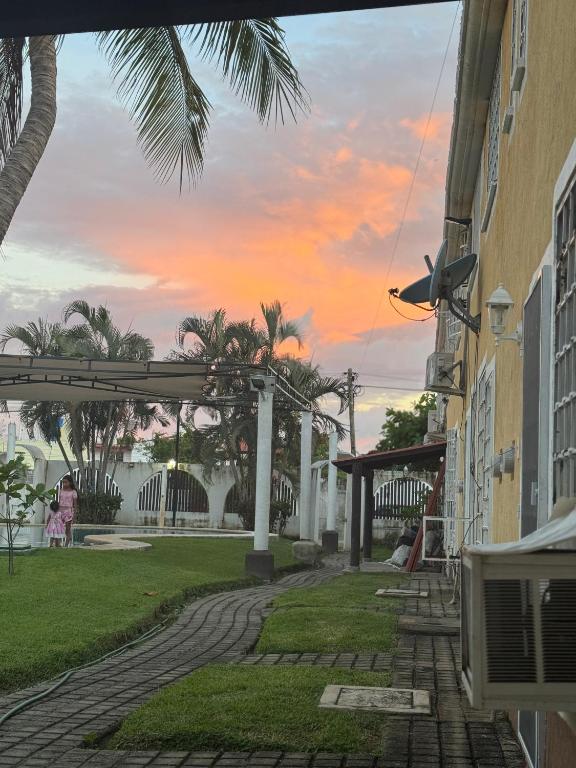 a view of a house with a pergola and palm trees at Casa Marquesa 3 Habitaciones in Acapulco