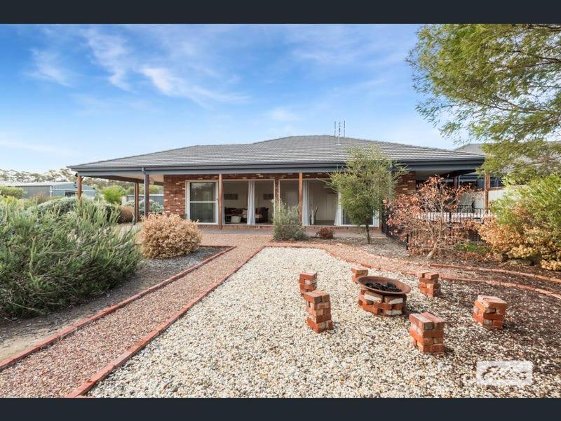 a house with a gravel yard in front of it at Apartment in Axedale