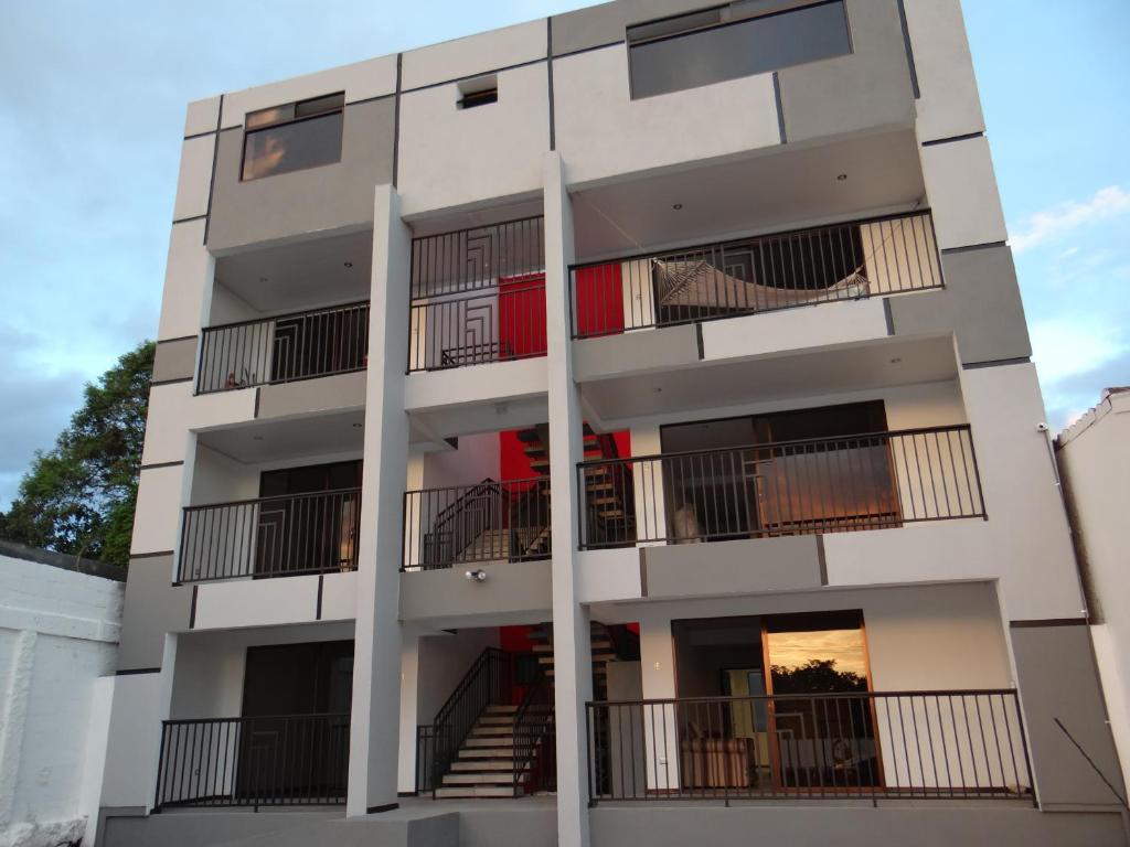 an apartment building with balconies on the side at Maria´s Apartments in Alajuela City