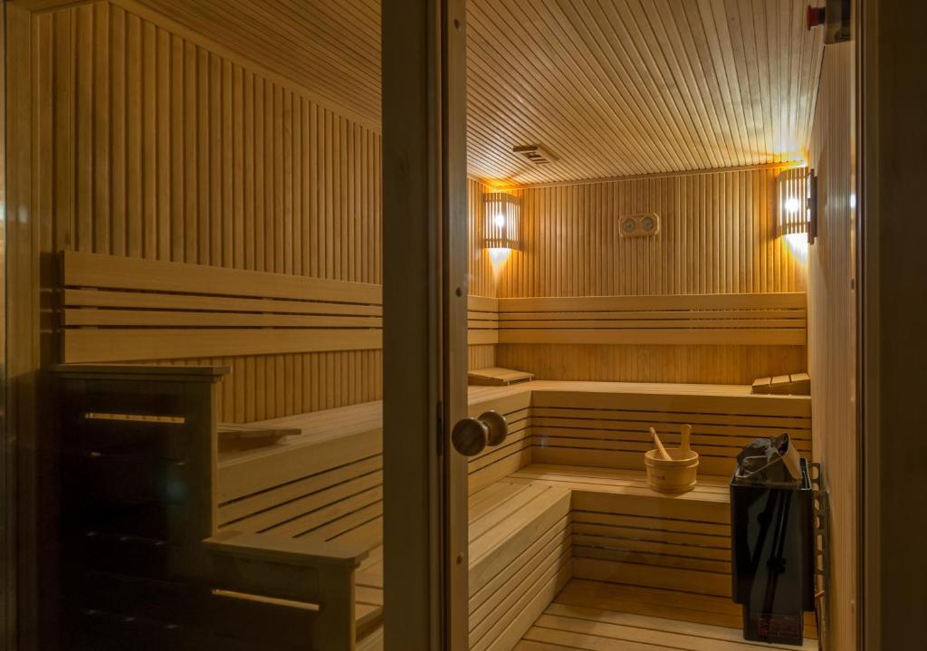 a sauna with wooden walls and wooden floors and a door at Régie Ottoman Istanbul - Special Category in Istanbul