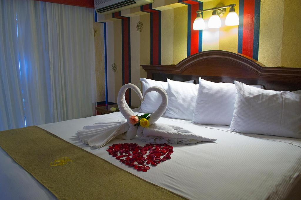 Postel nebo postele na pokoji v ubytování Hotel Plaza Colonial