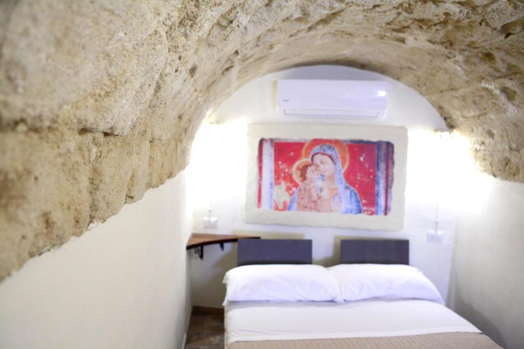 Postel nebo postele na pokoji v ubytování La Pergola ai Sassi