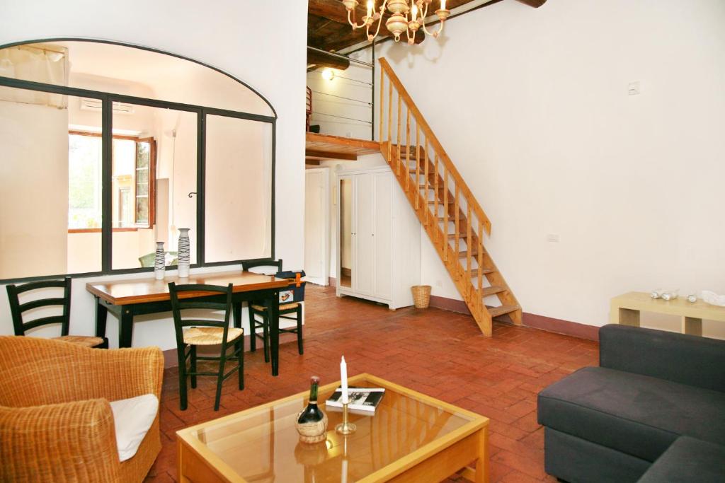 a living room with a couch and a table and a staircase at Casa Sophie in Florence