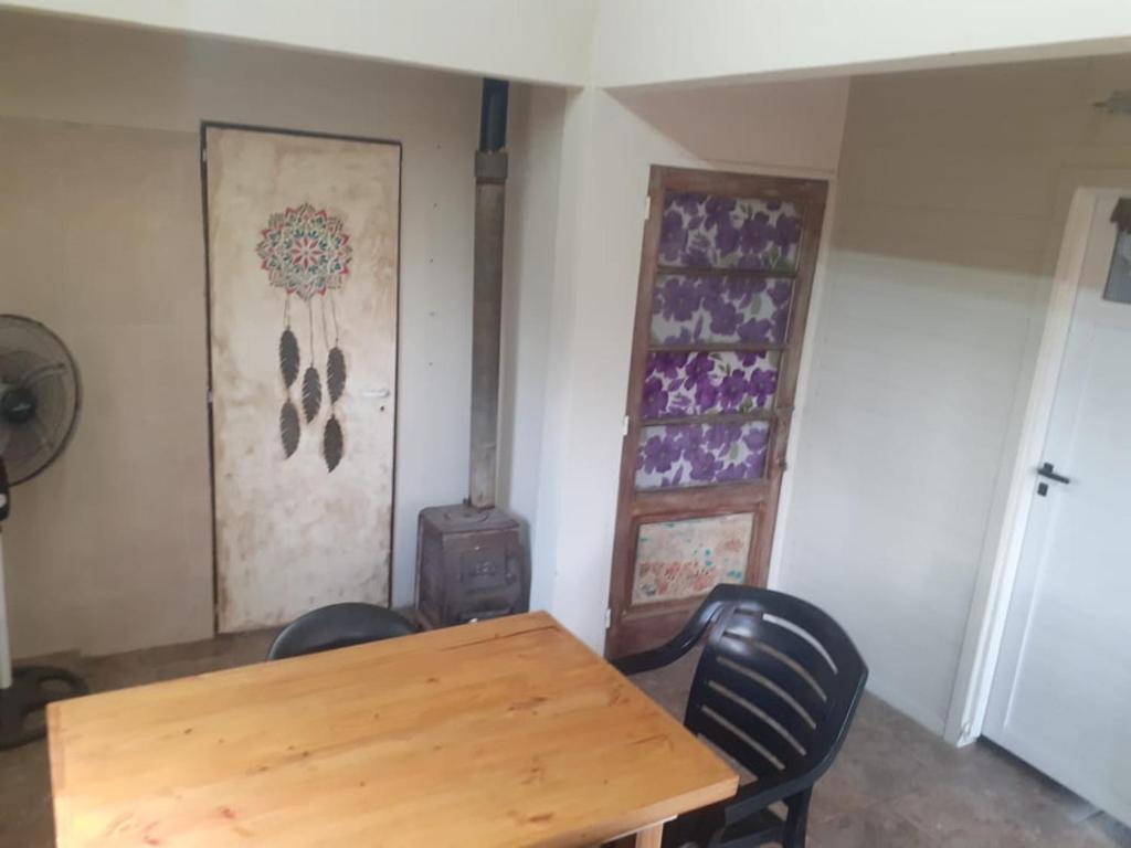 a dining room with a wooden table and chairs at Limones in Mariano Moreno