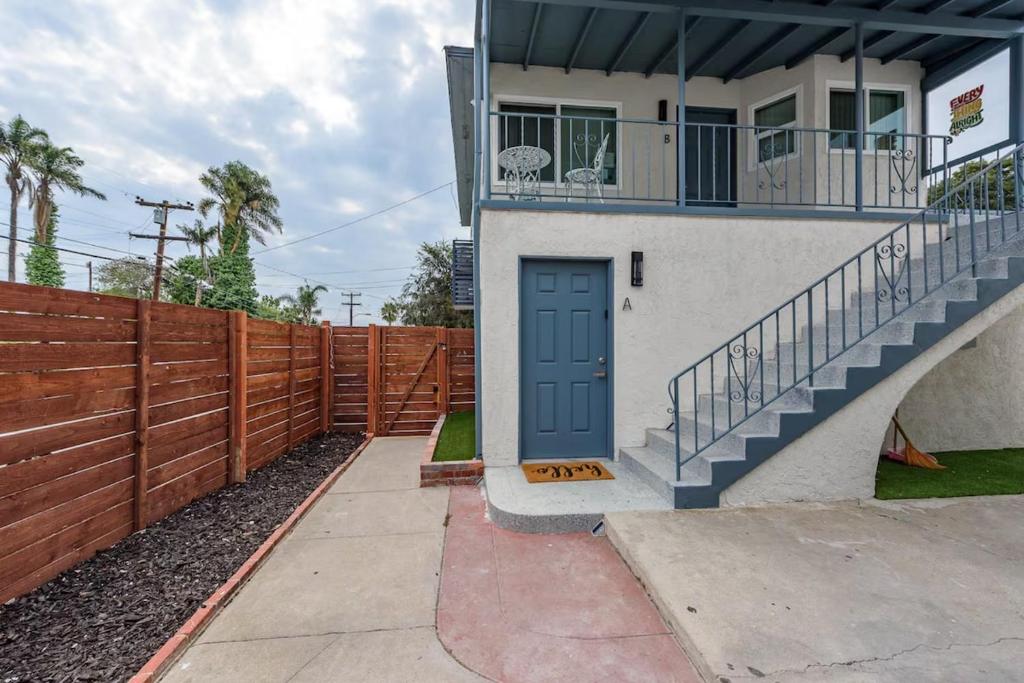a house with a blue door and a fence at Central San Diego 2 BED Condo in San Diego