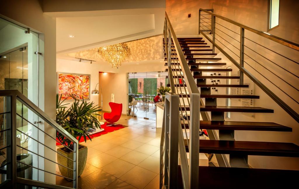 a living room with a staircase in a house at Elements Hotel Boutique in Managua