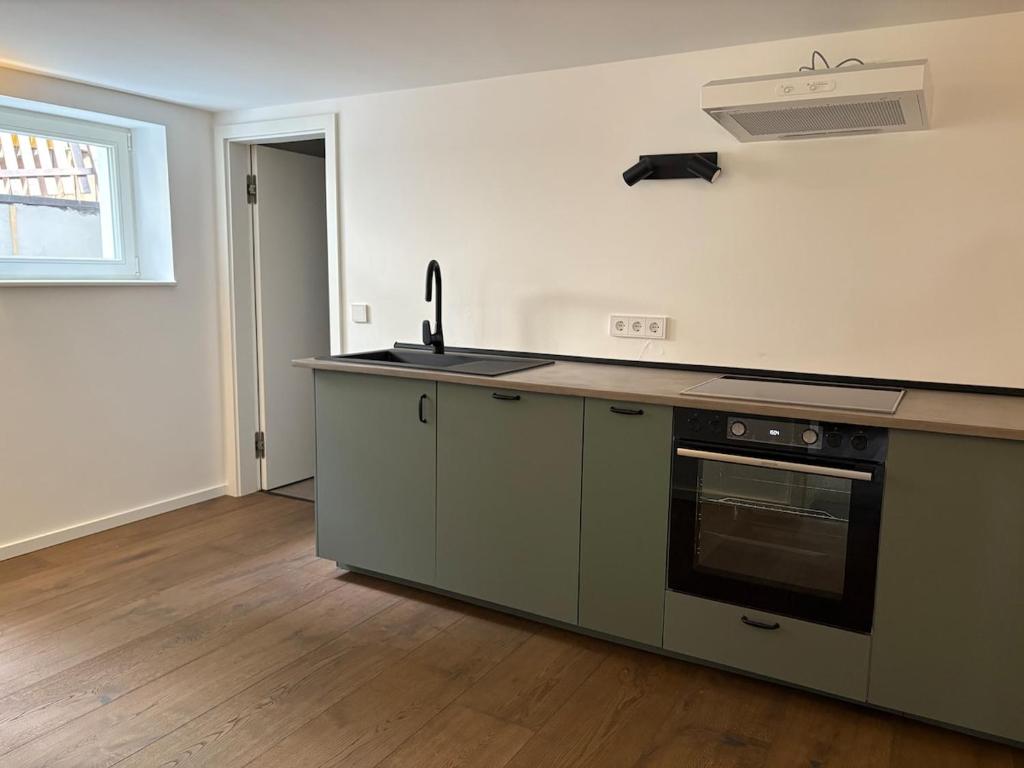 an empty kitchen with a stove and a sink at Waldblick am Rhein - Natur & Citynah - in Bonn