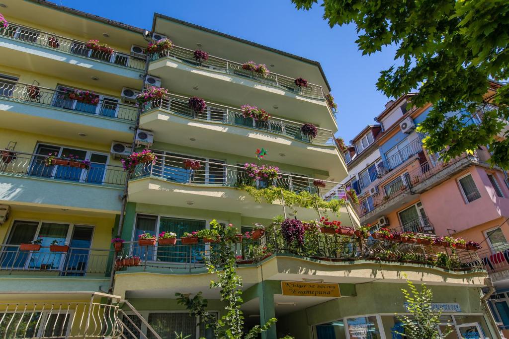 an apartment building with flower boxes on balconies at Guest House ,, Ekaterina" in Nesebar