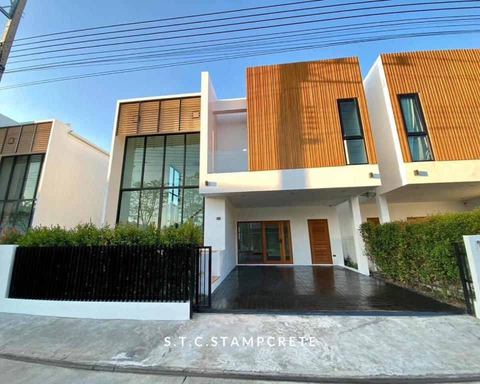 a house in the middle of a street at Modern House Uprompt Chiangmai in Chiang Mai