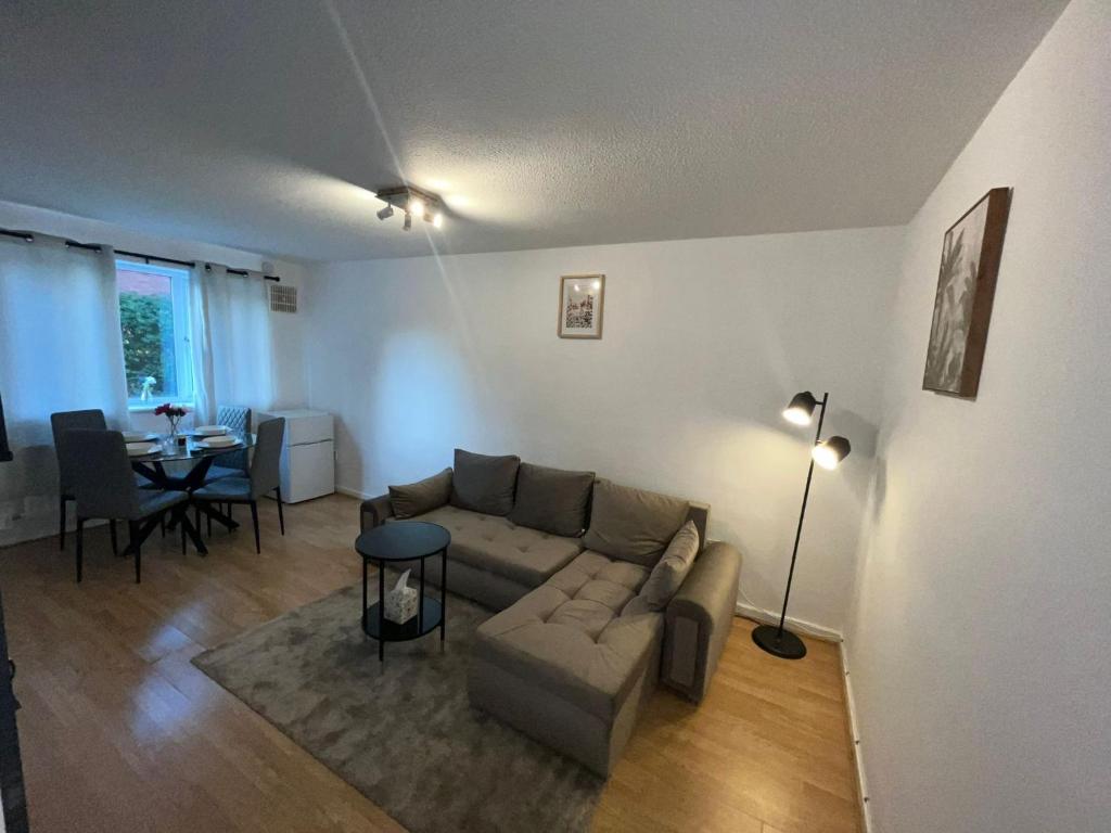 a living room with a couch and a table at Stylish 1 Bed Apartment - Birmingham city Centre in Birmingham